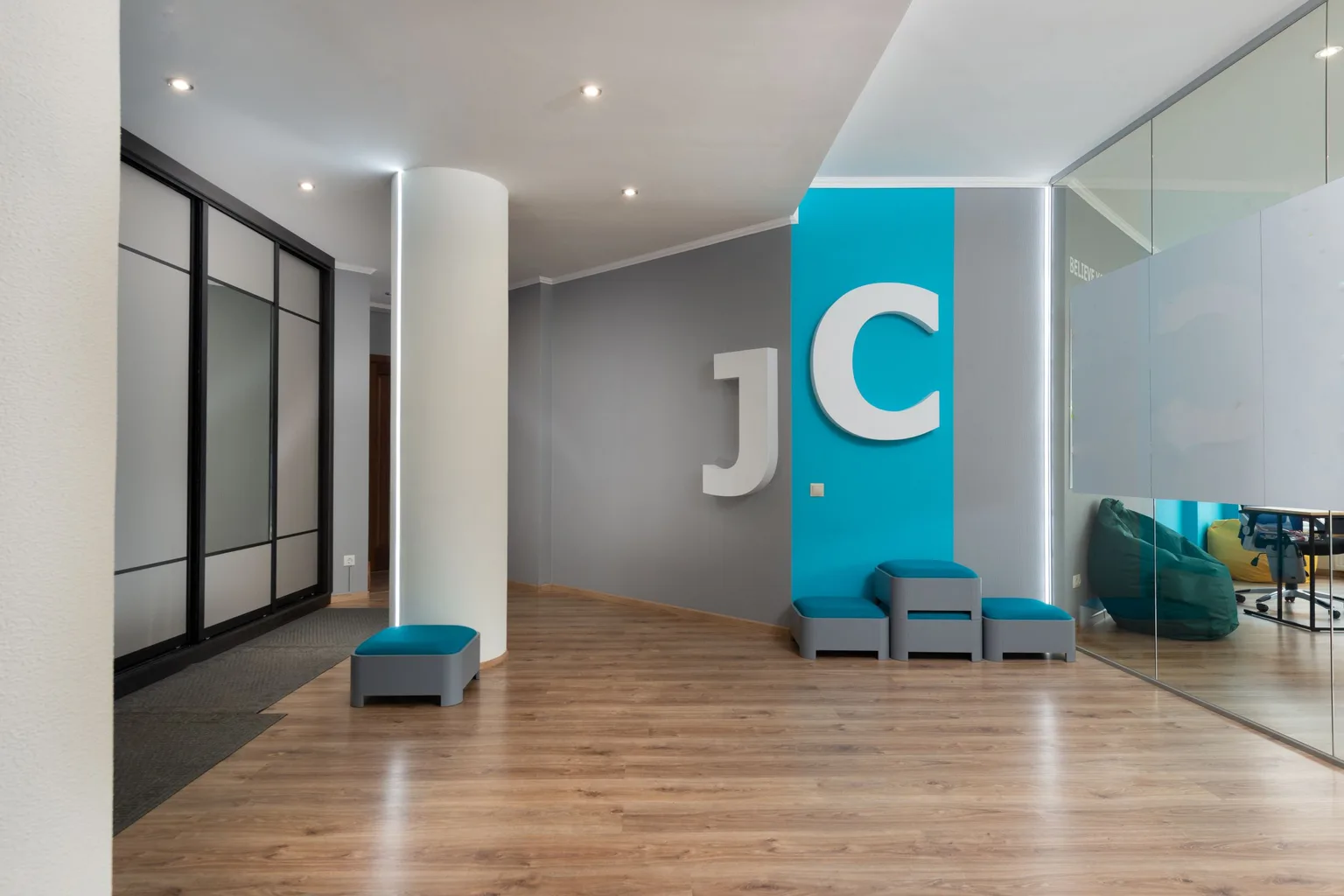 A modern, spacious office hallway with clean carpet flooring