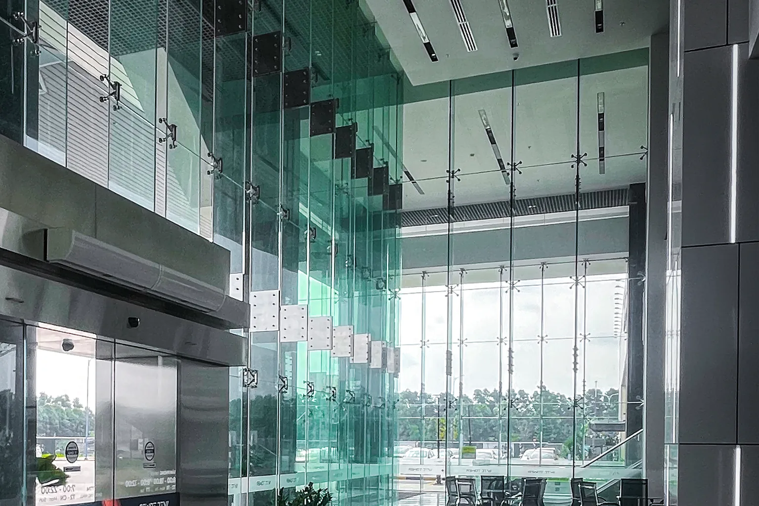 A modern corporate building lobby with glass walls