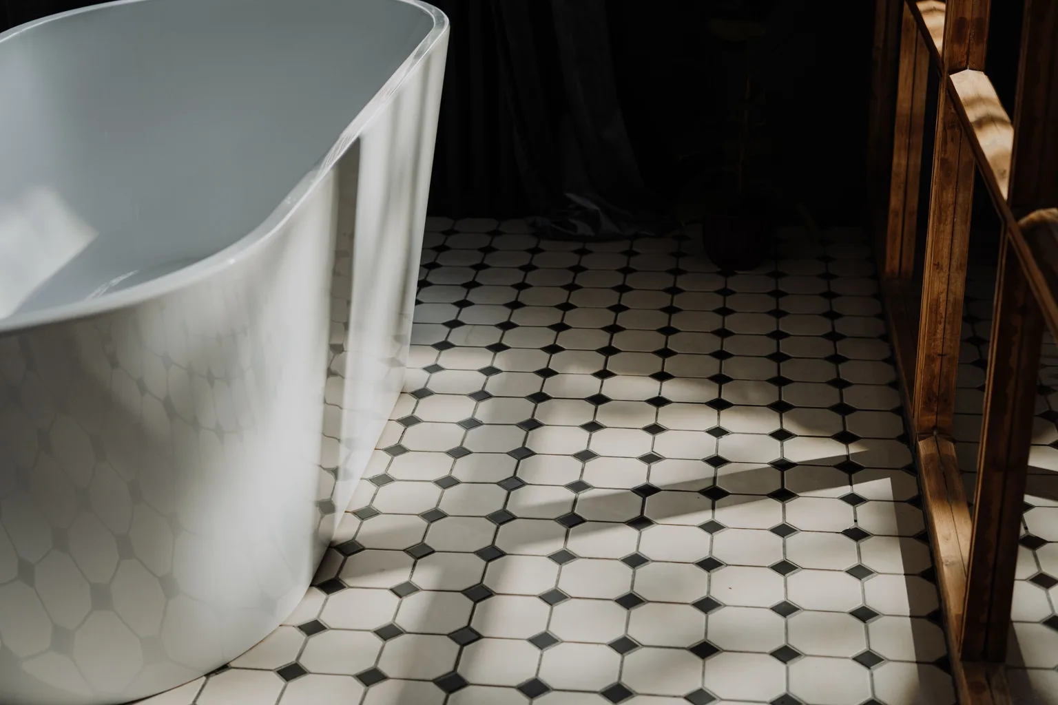 A clean bathroom with patterned floor tile and visible grout lines
