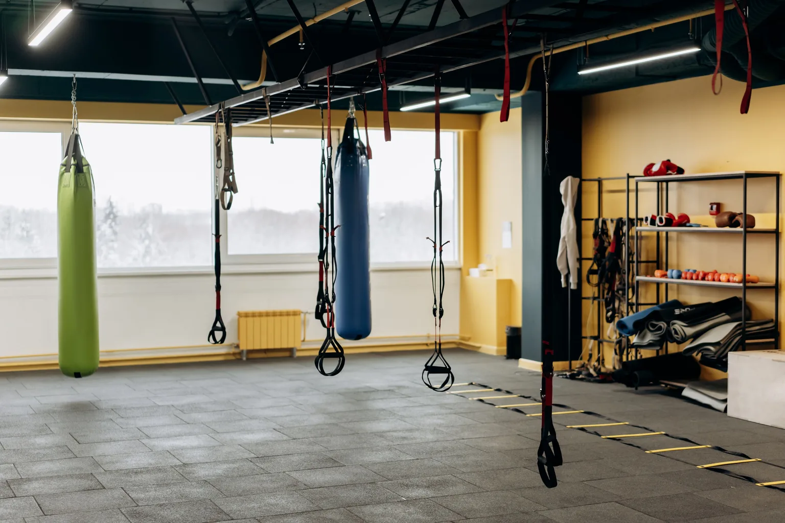 A modern gym interior with open floor space and training equipment