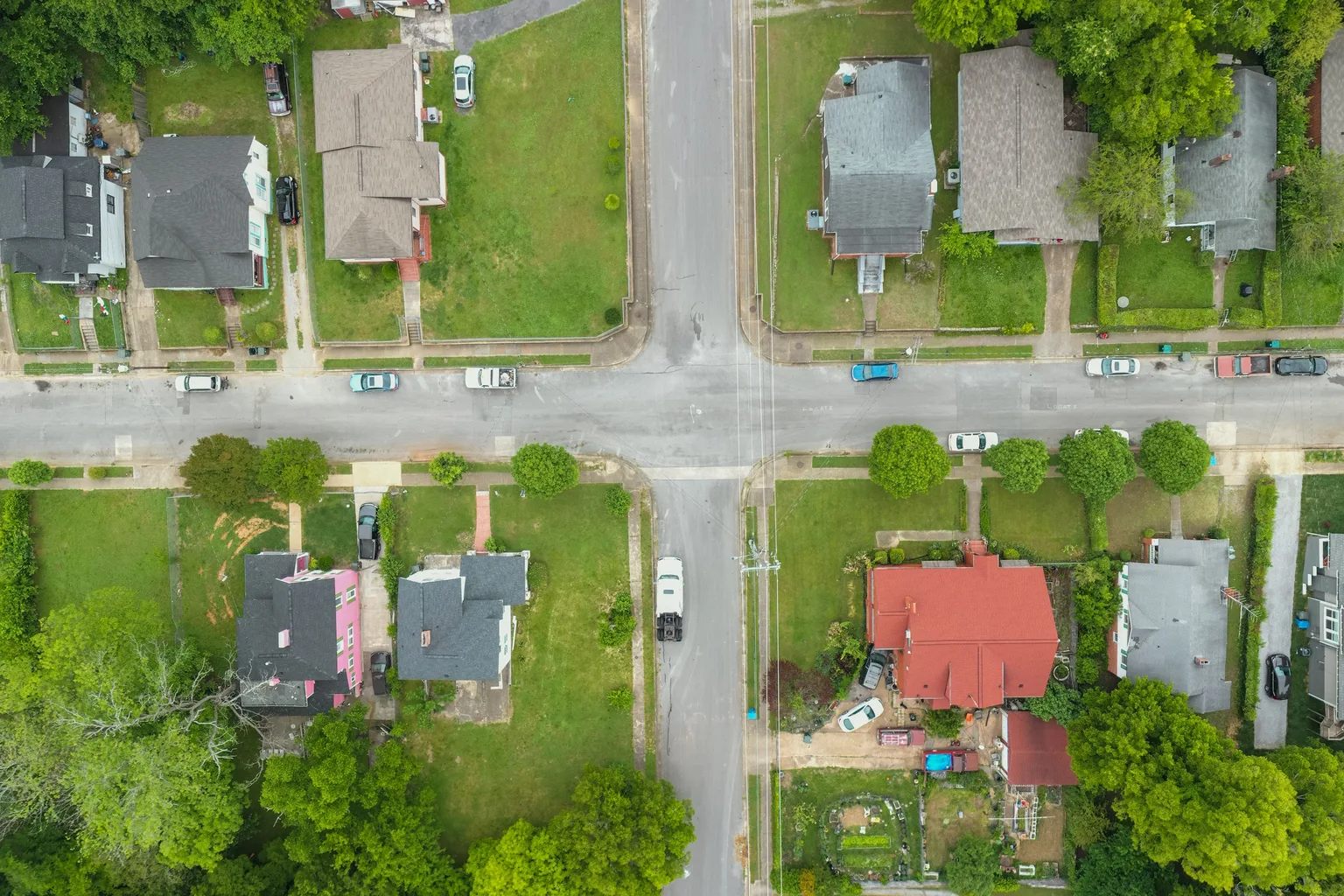 Overhead view of an older residential neighborhood grid with mature trees and modest homes
