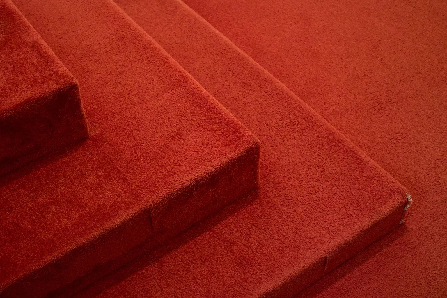 Close-up of stairs covered with red carpet