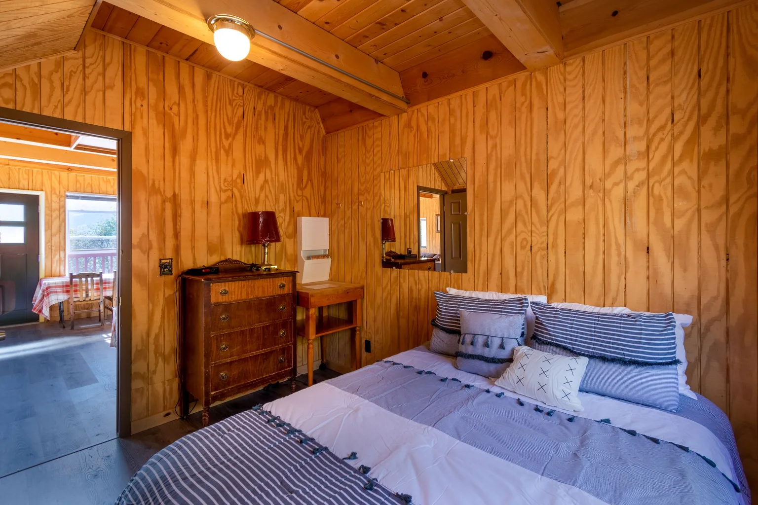A cozy bedroom in a wooden vacation rental house
