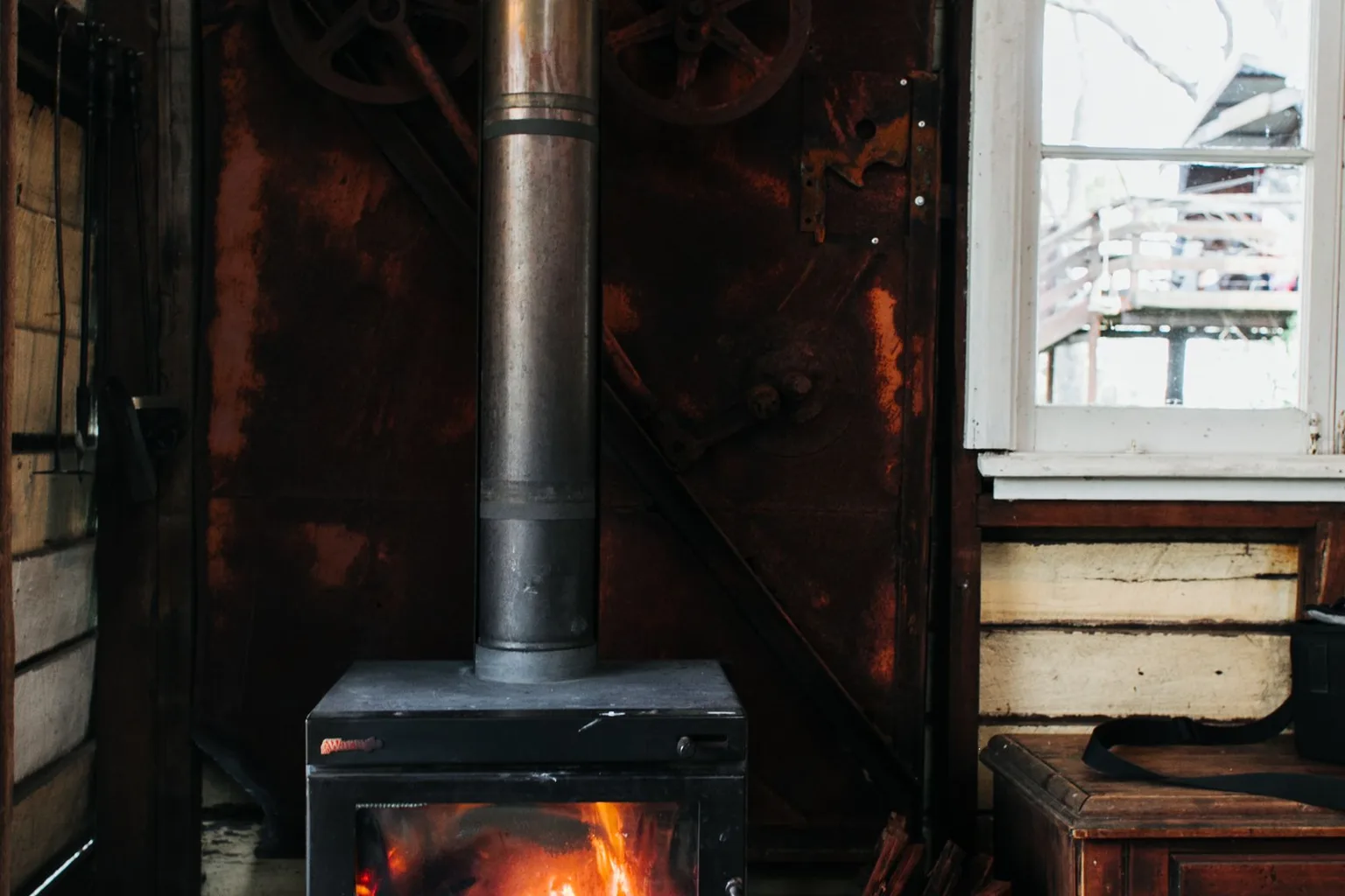 A fireplace burning in an old-fashioned house interior